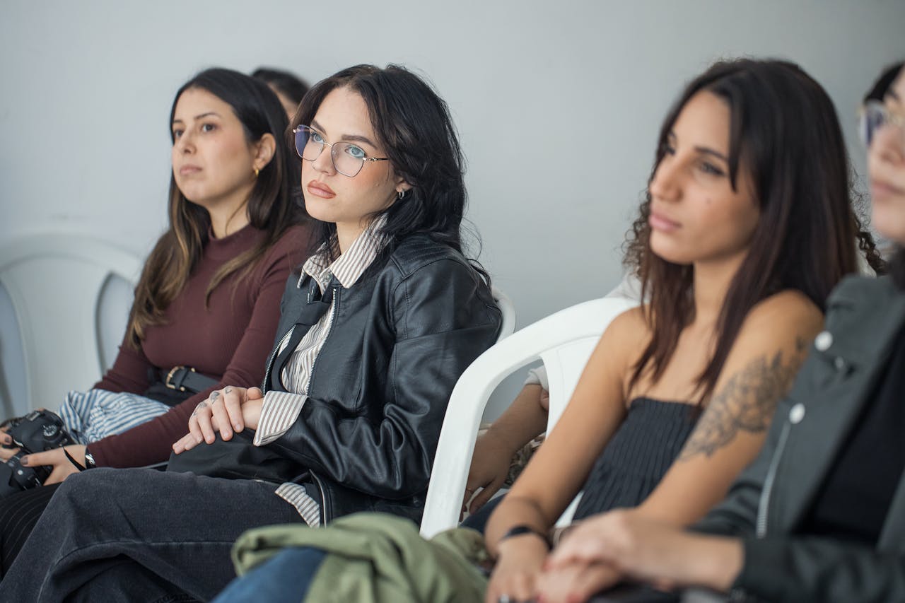 Focused individuals attending an indoor seminar, showcasing engagement and learning.